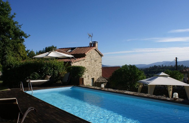 Stone house with pool and garden.