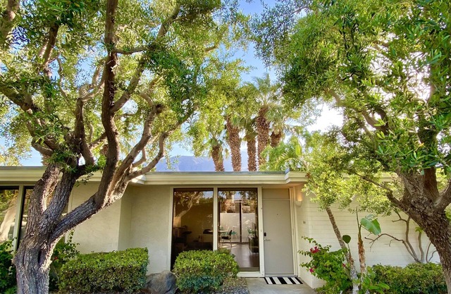 Stylish and sun filled condo with mountain views, private patio and lush grounds