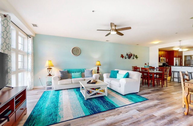 Sunlit single-level condo with pool, washer/dryer, central AC, & balcony