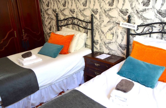 This room has two single beds with an en-suite bathroom. The room has views of the village square.