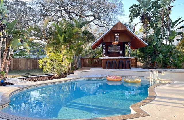 Tiki Oasis on 0.6 acres- 5 min to the beach, clean and modern.