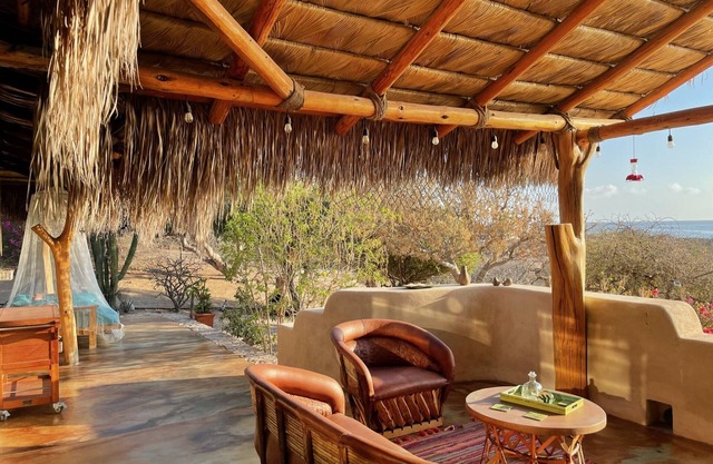 Traditional stone palapa retreat with ocean and desert views