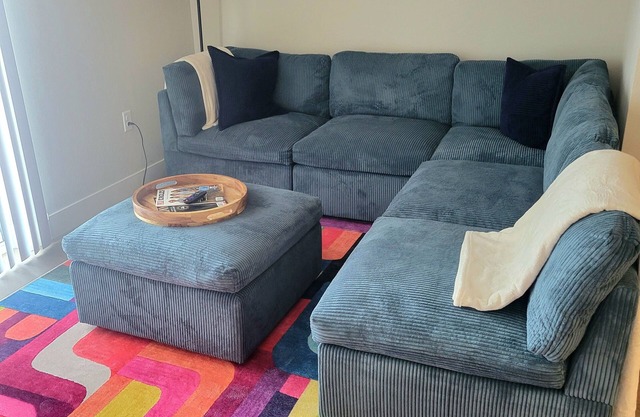 Unwind in Comfort – Modern 1BR w/Pool, Gym, Free Parking & a Cozy Sectional to Lounge In