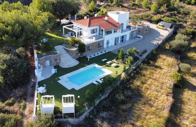 Villa surrounded by greenery with sea view and swimming pool