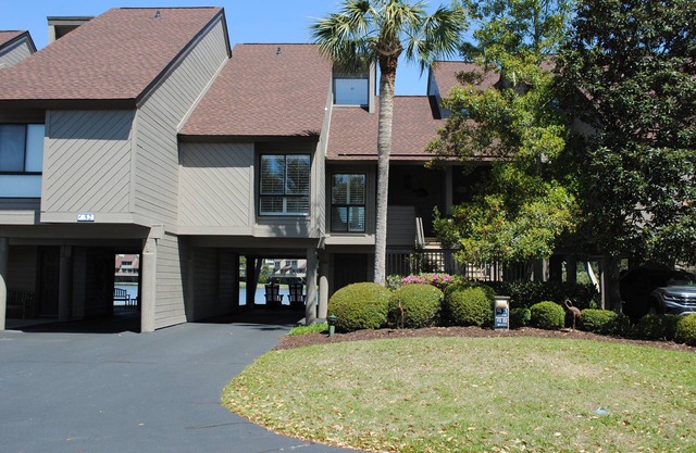 Villa with lake views and pool access located within gated Litchfield By the Sea community.