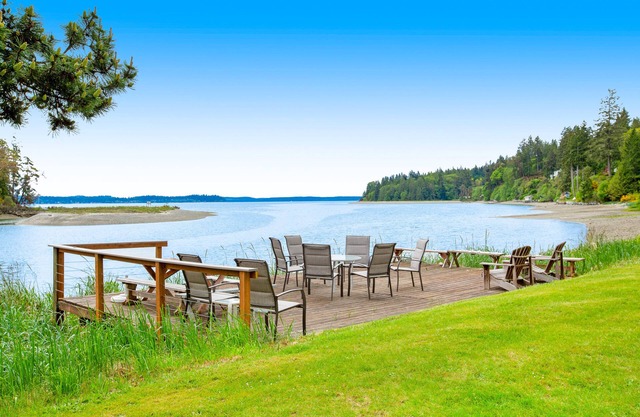 Waterfront retreat with private beach, cookhouse, hot tub, EV charger, & firepit