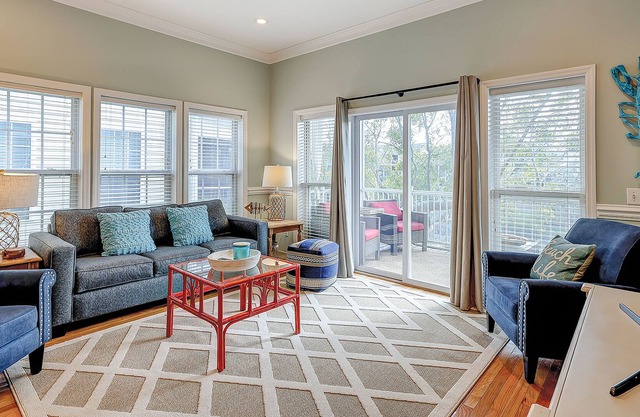 Welcoming water view townhome with pool, balcony, deck, & kitchen