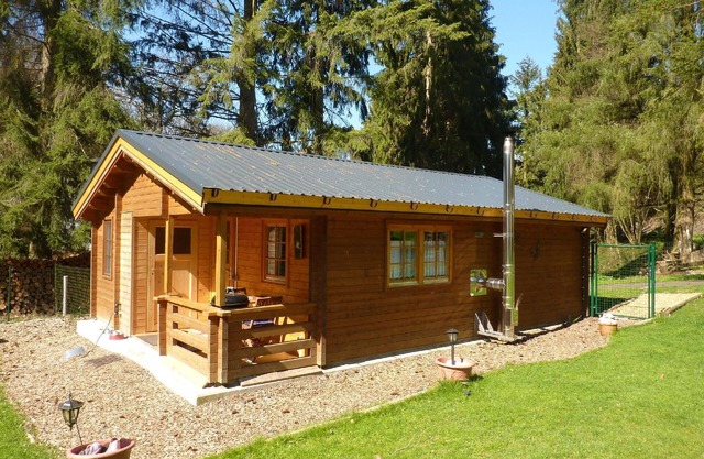 Wooden cabin is situated right by the forest, with the Deimerbach stream meandering past the fully fenced site