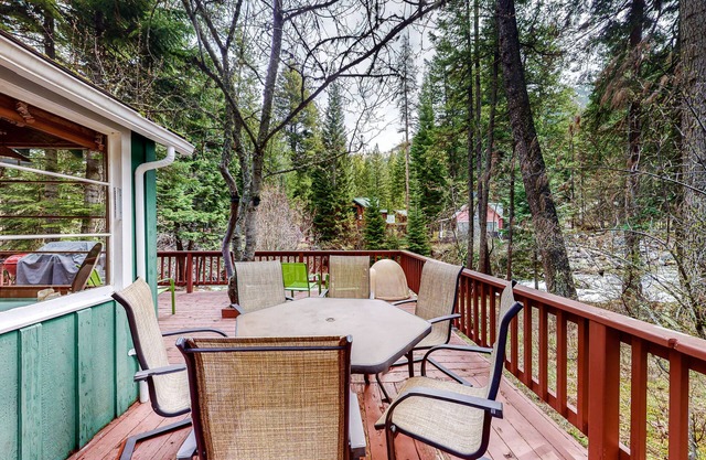 Woodsy riverfront basecamp with fireplace, large deck & firepit - dogs welcome