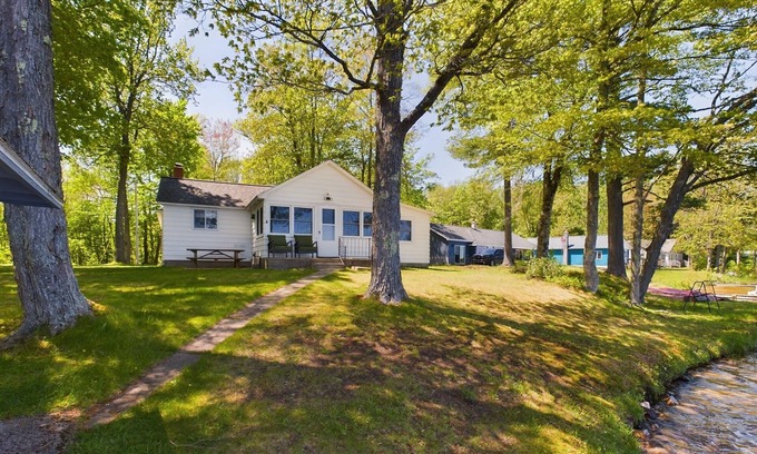 Munising Cabin | 16 Mile Lake Getaway-Lakefront with Water Toys & Family Time Around a Fire