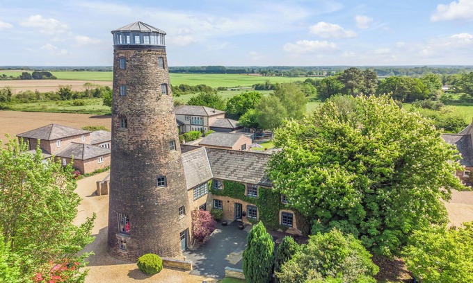 Stoke Ferry House | 7 Storey Listed Windmill, dog friendly with outdoor pool & bbq