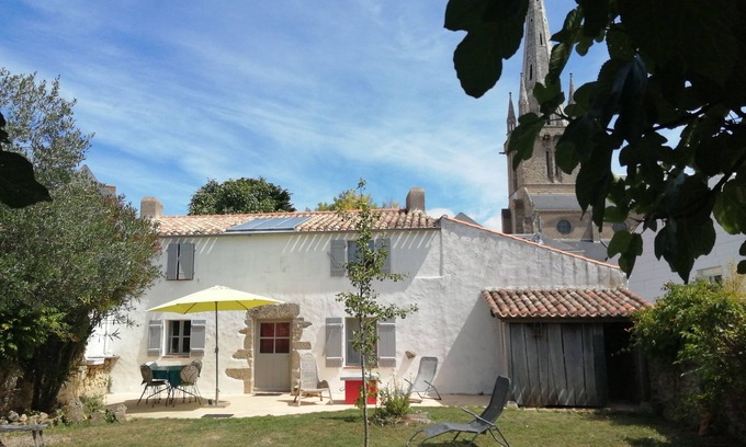 Bouin Cottage | a charming little house deep in a fenced garden with stone walls