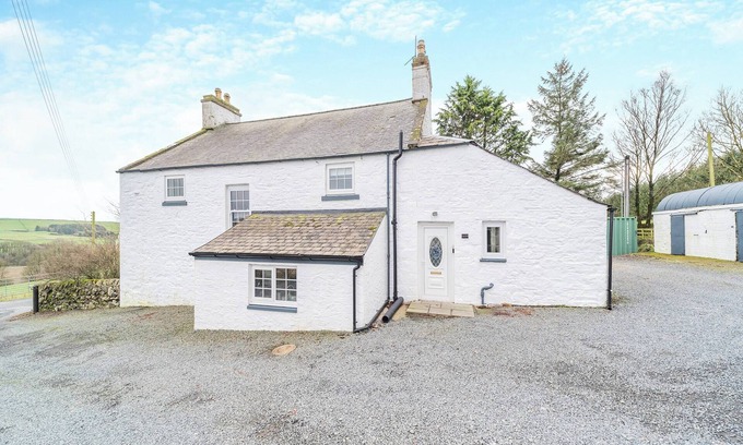 Newton Stewart Cottage | A large, detached farmhouse with open views of the countryside.