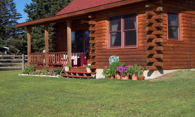 Nadeau House | A Log House on a Sand Beach