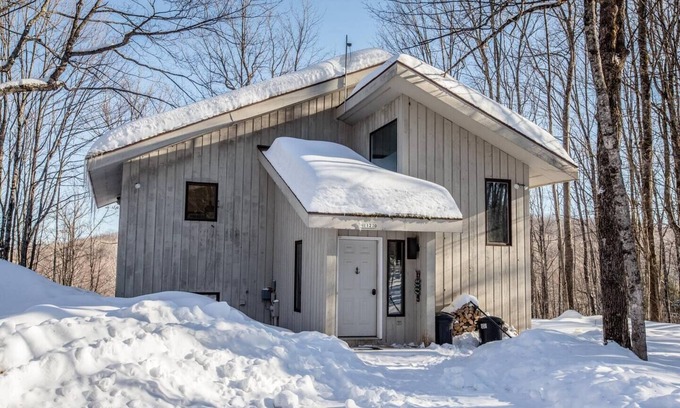 Bessemer House | A Spacious Vacation Home in a Wooded Setting With A Brick Fireplace