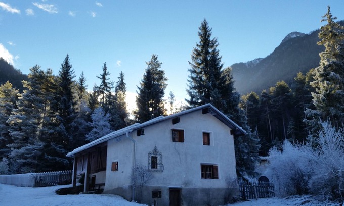 Sent House | Ancient typical Engadine mill on a stream near the woods and walks