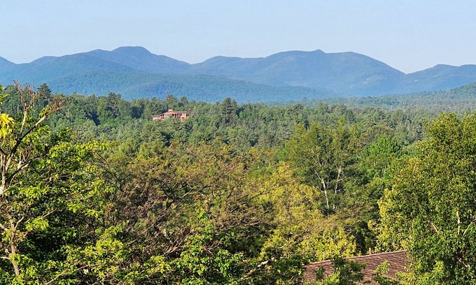 Lake Placid Apartment | Awesome mountain view with private patio, Fantastic location right on Main St.