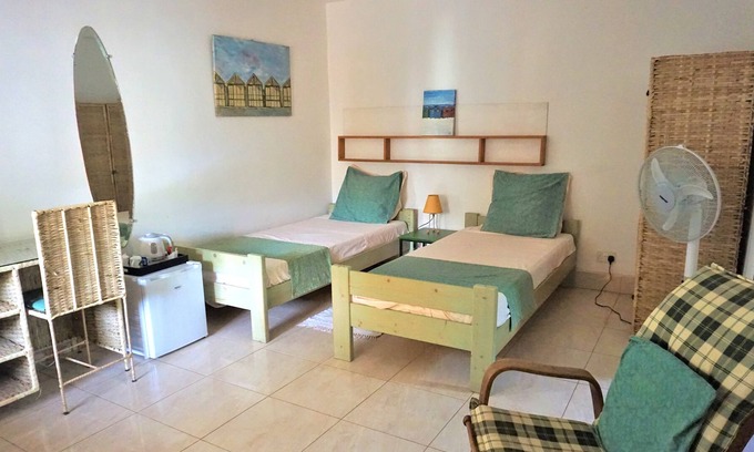 Serrekunda Bed & Breakfast | B & B Villa Calliandra, lovely cool room with single beds in quiet area, pool.