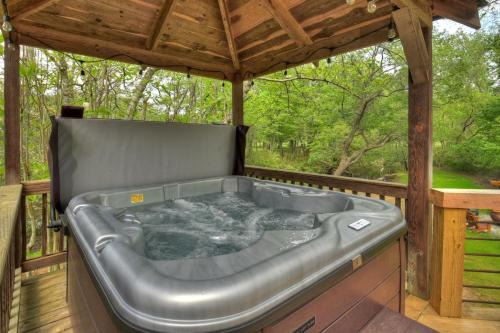 Epworth Villa | Bear Naked Hideaway - Relax in the hot tub with sounds from the nearby creek