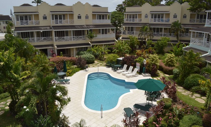 Marine Gardens Condo | Beautiful Condo with breezy Balcony Overlooking Pool & Garden – Steps to Beach