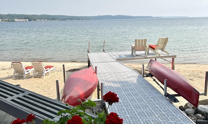 Suttons Bay House | Big Sandy Beach !Walk to Village! Suttons Bay Waterfront Cottage.