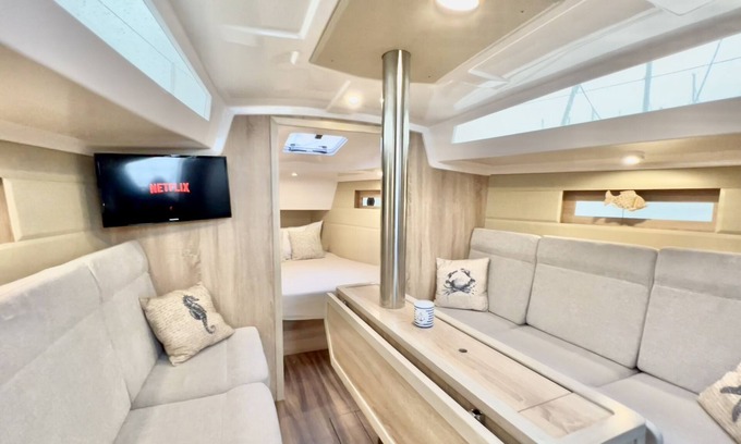 Ostholstein Boat Rental | Boat 'Hausboot Segelyacht Nui' on the sea and Private Terrace