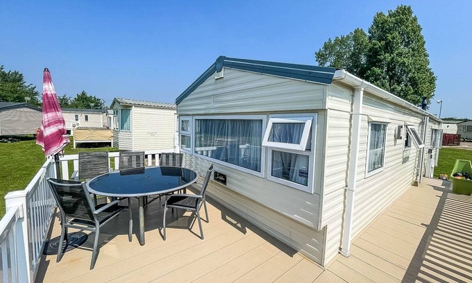 Colchester House | Caravan with large decking at Coopers Beach Holiday Park ref 49036TS