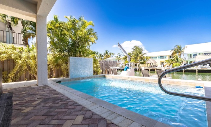 Coury House | Casa Paraiso: Discover This Charming 2BR Canal Front Duplex in KCB with Private Pool & Dockage!