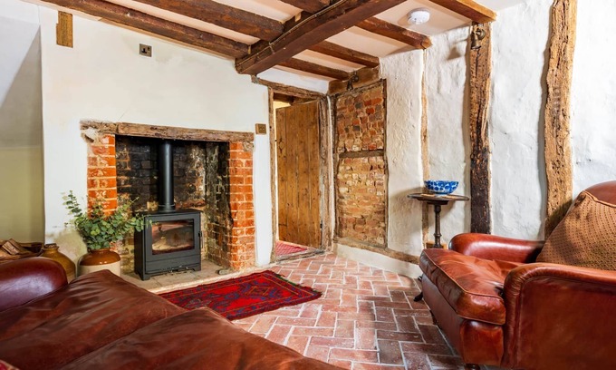 Ipswich Cottage | Charming medieval cottage courtyard garden and wood burner in serene Kersey