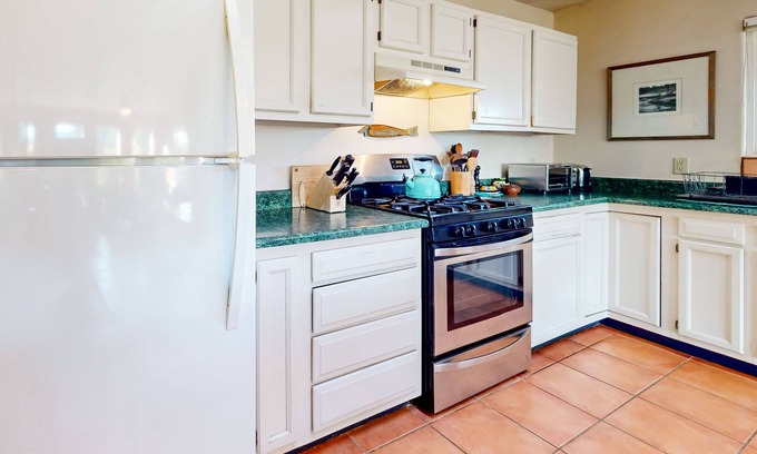 Taos House | Charming secluded home mountain views, covered front porch, & book collection