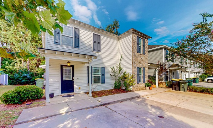 Savannah House | Charming townhome with tree-lined deck, pool and dock access, & updated interior