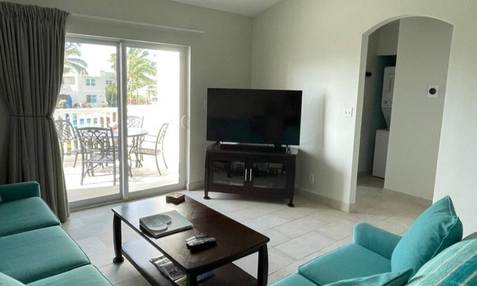 Wheeland Settlement Condo | “Coastal Bliss: Stunning 2-Bedroom Condo with breathtaking Beach and Pool Views”