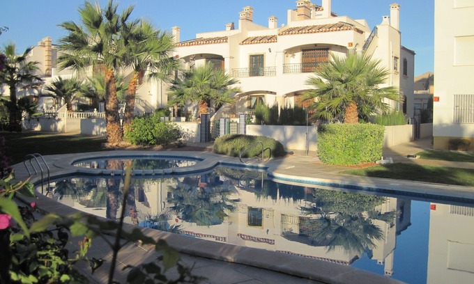 Orihuela Costa Apartment | condo in cozy garden beside the pool.