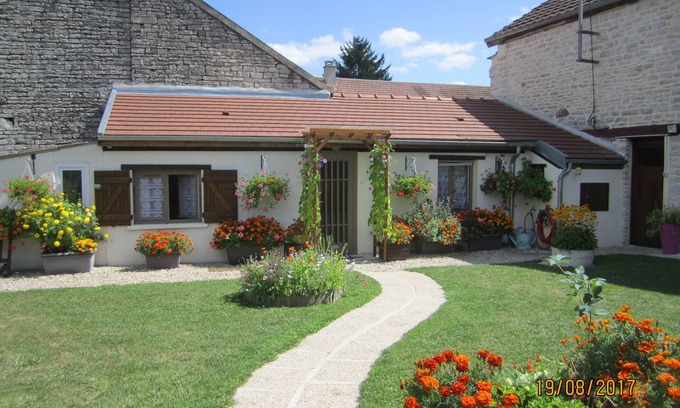 Tanlay Cottage | cottage commissey in a flower garden