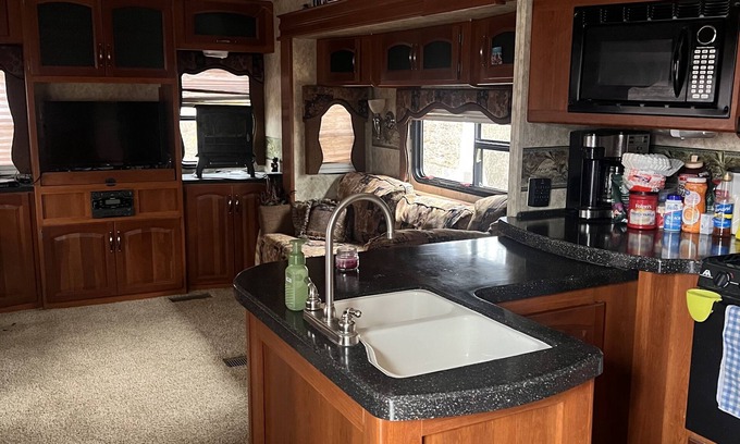 Charlotte House | Cozy camper trailer with great views of the sky. Fire pit great for entertaining