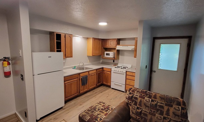 Bellaire RV Rental | Cozy little cabin in a campground backed up to the peaceful woods.