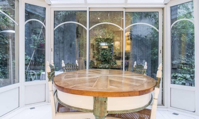 16th Arrondissement Apartment | Cozy Parisian style apartment with a veranda overlooking a private garden.