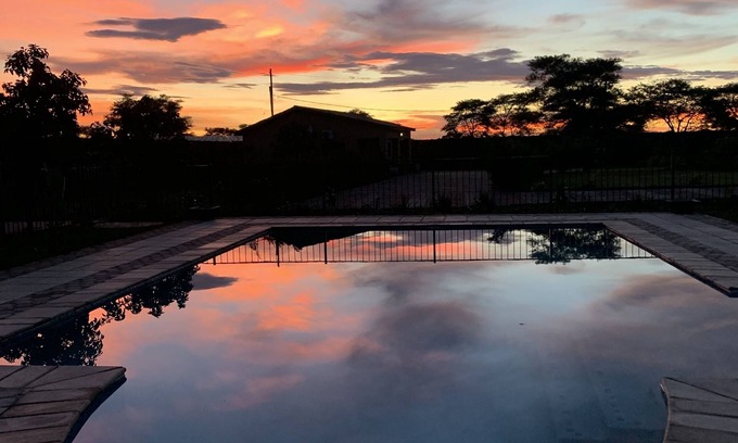 Lusaka Cottage | Cozy, quiet and beautiful two bedroom gated cottage. Full kitchen & pool access.