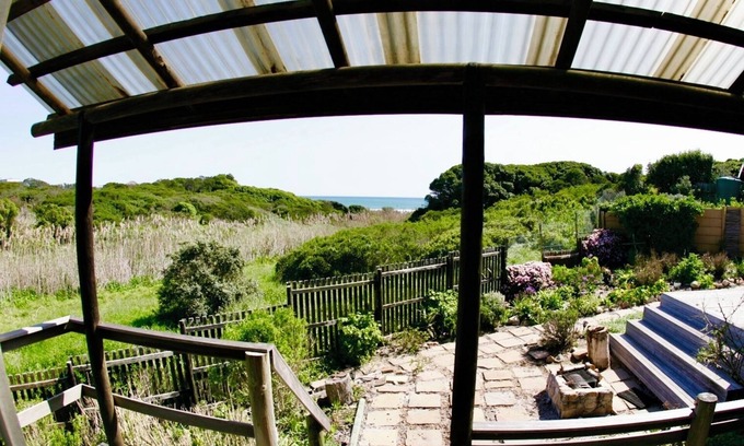 Kommetjie Apartment | Cozy Retreat: 1-Bedroom with stunning sea view down serene green belt."