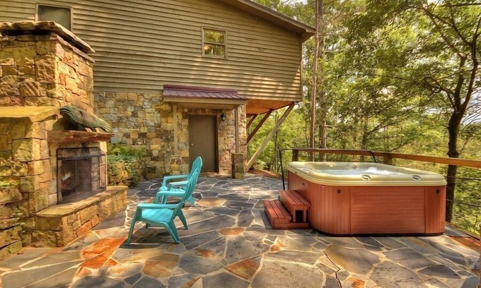 Ellijay Cabin | Discover River Bluff Retreat, a Pet-friendly haven with riverfront access for tubing and fishing, plus hot tub, outdoor fireplace, dock, and WiFi.