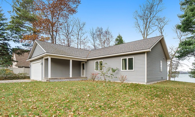 Empire House | Enchanting lakefront home with firepit, patio, grill & washer/dryer