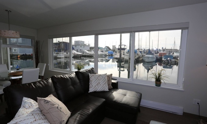 Lower Lonsdale Boat Rental | Encounter paradise at the oceans edge in a high-end floating home! Pets welcome.
