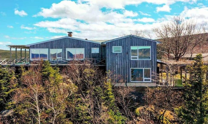 White Point Cottage | Enjoy the stunning views of the Cape Breton Highlands atop this cliffside estate