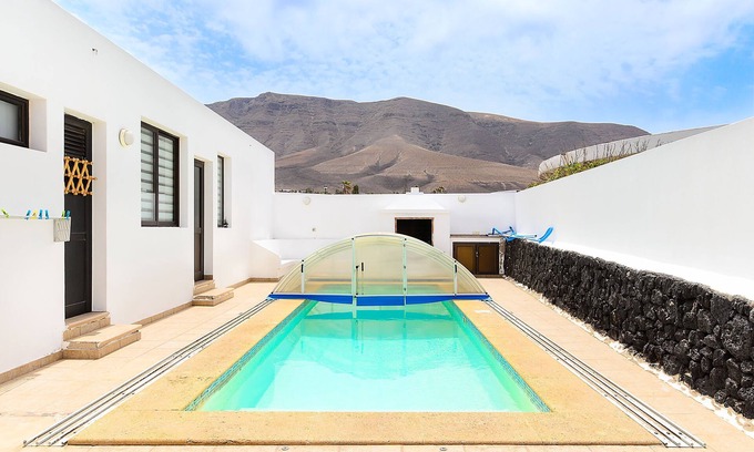 Urbanizacion Famara Apartment | Famara Beach Apartment on the Shore with Shared Pool, Terrace, Ocean/Mountain Views & Wi-Fi