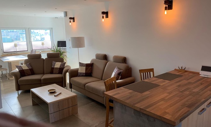 Langwedel Apartment | First floor vacation apartment on approx. 78 sqm, high-quality and modern furnishings with furnished terrace with garden pond and barbecue facilities, covered e-bike charging station and lockable bicycle room. You can look forward to: a fully equipped.