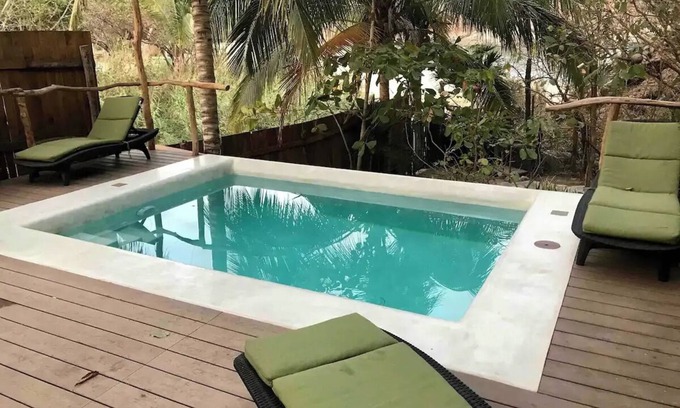 Arroyo Cruz House | Great room with deck pool in front of perfect bay