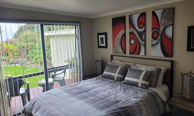Collingwood Apartment | Great room with lovely view of the garden and beyond that Golden Bay