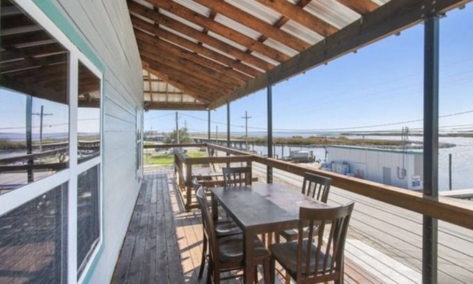 Delacroix Cabin | Great view of bayou-fishing lodge- sleeps 6. Fish cleaning station & BBQ pits.