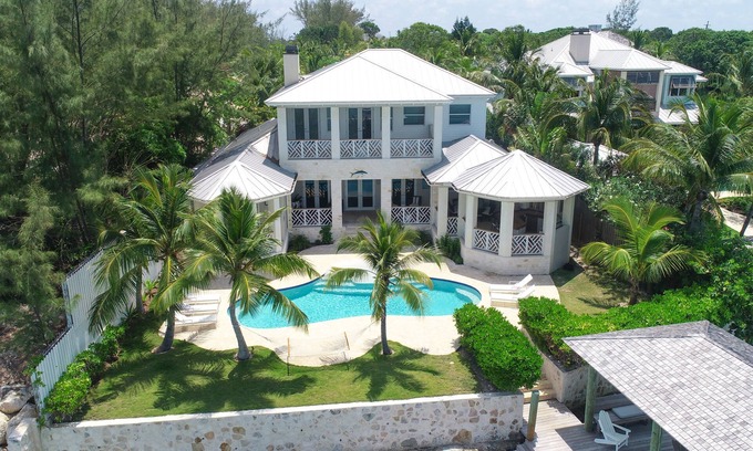 Dunmore Town House | Harbor Island Oceanfront Escape. Private Dock, Heated Pool & Sunset Views.