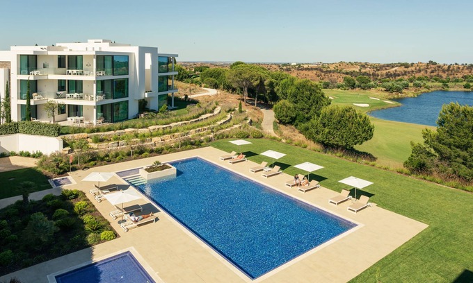 Vila Nova De Cacela Apartment | Heated pool, lush gardens, and air conditioning at Monte Rei.